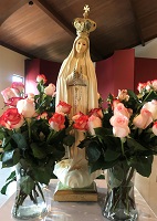 Mary surrounded by roses on Monther's Day